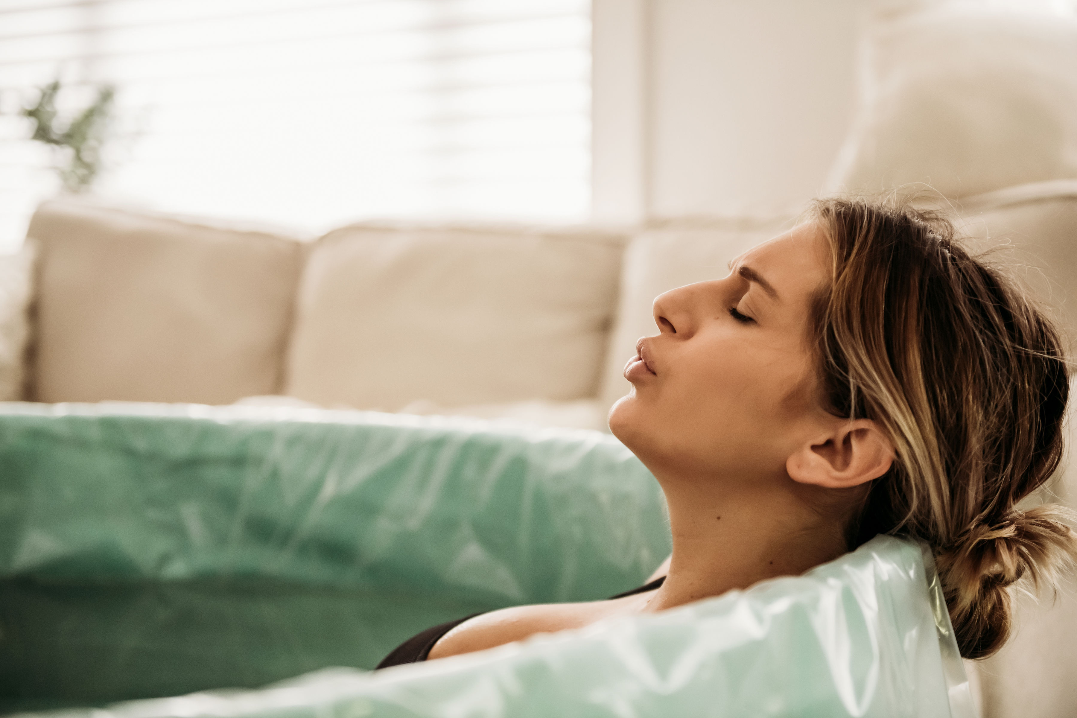 Woman breathing calmly in her birth tub. Woman breathing calmly in her birth tub.