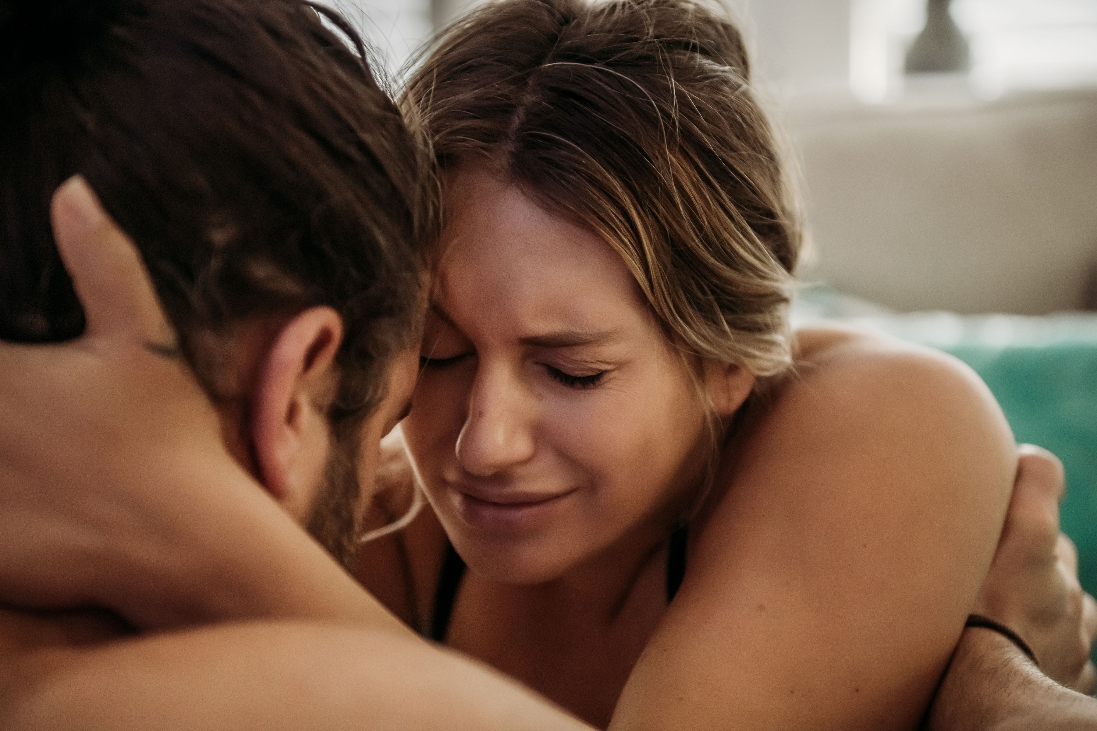 Gentle Pain Management Man and woman in birth tub holding each other and breathing through pain.